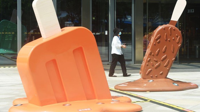 HANGZHOU, CHINA - AUGUST 02: A citizen walks by popsicle-shaped installations outside a shopping mall amid a heat wave on August 2, 2022 in Hangzhou, Zhejiang Province of China. (Photo by Long Wei/VCG via Getty Images)