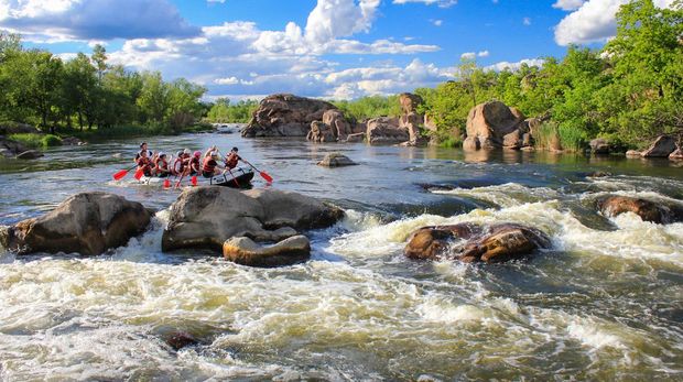 Pacuare River, Costa Rica -MAY  15 2021: Rafting team , summer extreme water sport. Group of people in a rafting boat, beautiful adrenaline ride down the river.