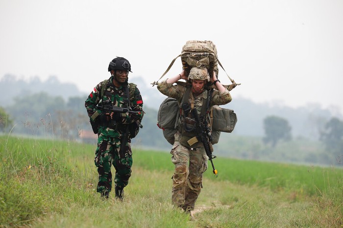 Indonesian Armed Forces Chief Gen. Andika Perkasa, center, and Gen. Charles Flynn, Commanding General of U.S. Army Pacific, left, put on a participant badge to a U.S. soldier during opening ceremony annual joint combat exercises in Baturaja, South Sumatra province, Indonesia, Wednesday, Aug 3, 2022. The United States and Indonesian militaries began annual joint combat exercises Wednesday on Indonesia's Sumatra island, joined for the first time by partner nations, signaling stronger ties amid growing maritime activity by China in the Indo-Pacific region. (AP Photo)