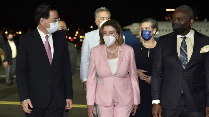 In this photo released by the Taiwan Ministry of Foreign Affairs, U.S. House Speaker Nancy Pelosi, center, walks with Taiwans Foreign Minister Joseph Wu, left, as she arrives in Taipei, Taiwan, Tuesday, Aug. 2, 2022. Pelosi arrived in Taiwan on Tuesday night despite threats from Beijing of serious consequences, becoming the highest-ranking American official to visit the self-ruled island claimed by China in 25 years. ( Taiwan Ministry of Foreign Affairs via AP)