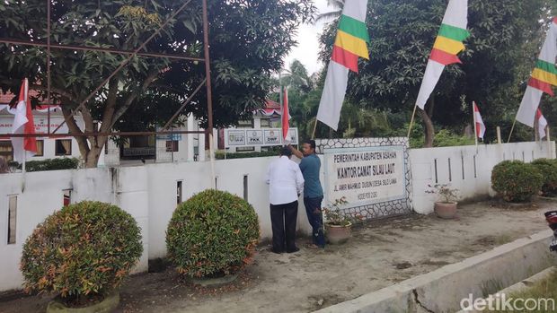 Perbaikan pemasangan bendera merah putih di Kantor Camat Silau Laut (Perdana/detikSumut)