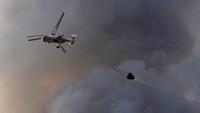 Helikoter pembawa bom air dikerahkan untuk memadamkan api yang terus membesar.