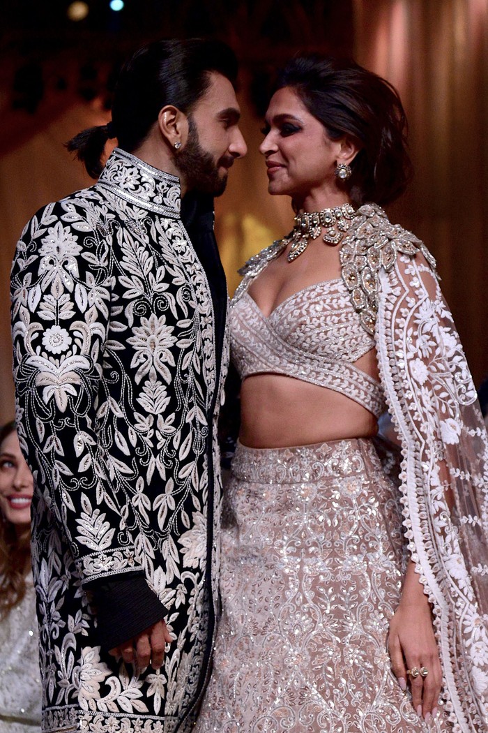 Deepika Padukone In this picture taken on July 29, 2022, Bollywood actors Ranveer Singh and Deepika Padukone walk the ramp for Mijwan Welfare Society and fashion show by designer Manish Malhotra in Mumbai. (Photo by SUJIT JAISWAL / AFP) (Photo by SUJIT JAISWAL/AFP via Getty Images)