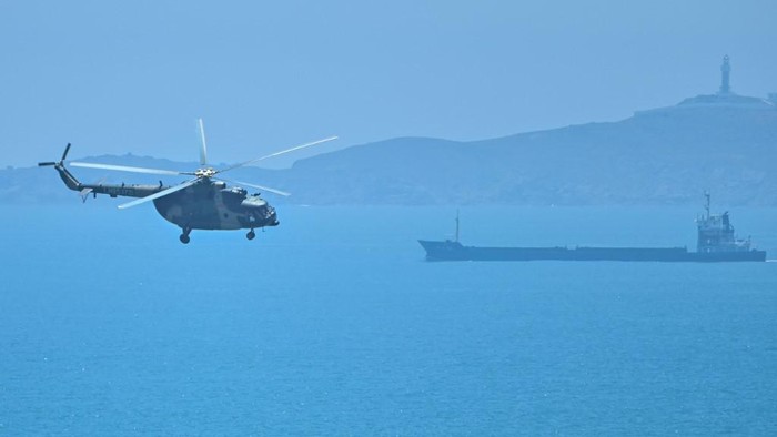 A Chinese military helicopter flies past Pingtan island, one of mainland Chinas closest point from Taiwan, in Fujian province on August 4, 2022, ahead of massive military drills off Taiwan following US House Speaker Nancy Pelosis visit to the self-ruled island. - China is due on August 4 to kick off its largest-ever military exercises encircling Taiwan, in a show of force straddling vital international shipping lanes following a visit to the self-ruled island by US House Speaker Nancy Pelosi. (Photo by Hector RETAMAL / AFP)