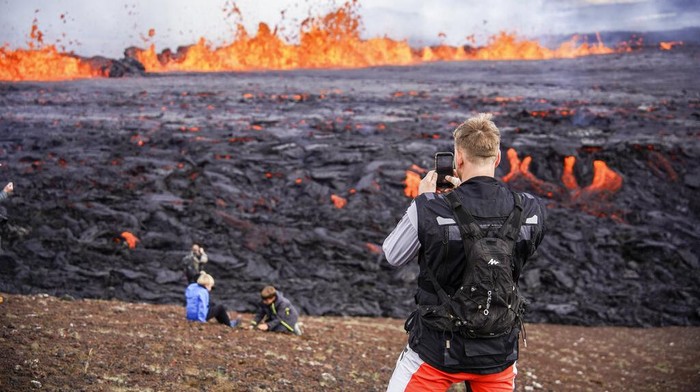 A close-up of the lava flowing from Fagradalsfjall volcano in Iceland on Wednesday Aug. 3, 2022, which is located 32 kilometers (20 miles) southwest of the capital of Reykjavik and close to the international Keflavik Airport. Authorities in Iceland say the volcano in the southwest of the country is erupting just eight months after its last eruption officially ended. (AP Photo/Marco Di Marco)