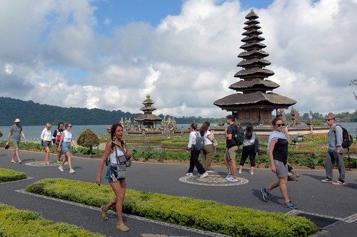 Wisatawan menikmati pemandangan objek wisata Ulun Danu Beratan saat berkunjung di Tabanan, Bali, Kamis (4/8/2022). Berdasarkan data dari Badan Pusat Statistik Provinsi Bali mencatat kunjungan wisatawan mancanegara ke Bali pada bulan Juni 2022 meningkat 57,10 persen yakni sebanyak 181.625 orang dibandingkan bulan Mei yang tercatat 115.611 orang, dan kedatangan wisman ke Bali didominasi wisatawan asal Australia. ANTARA FOTO/Nyoman Hendra Wibowo/foc.