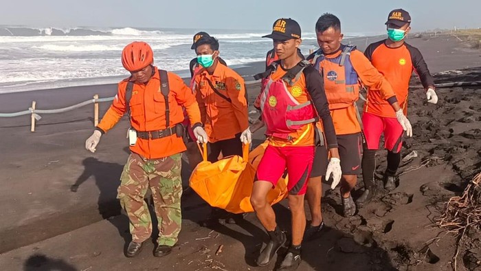 Petugas melakukan evakuasi warga tenggelam di pantai.