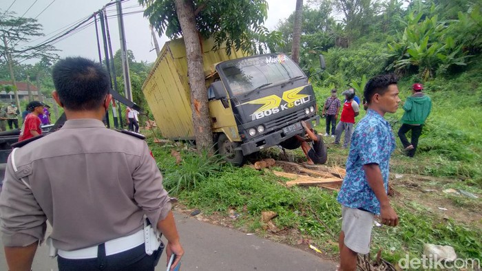 Warga dan petugas mengevakuasi pengendara motor yang diseret truk di Bandar Lampung.