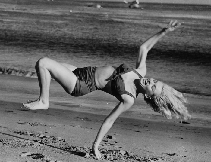 Marilyn Monroe (1926  - 1962) frolicking on the beach near her Hollywood home during a break from filming.   (Photo by L J Willinger/Getty Images)
