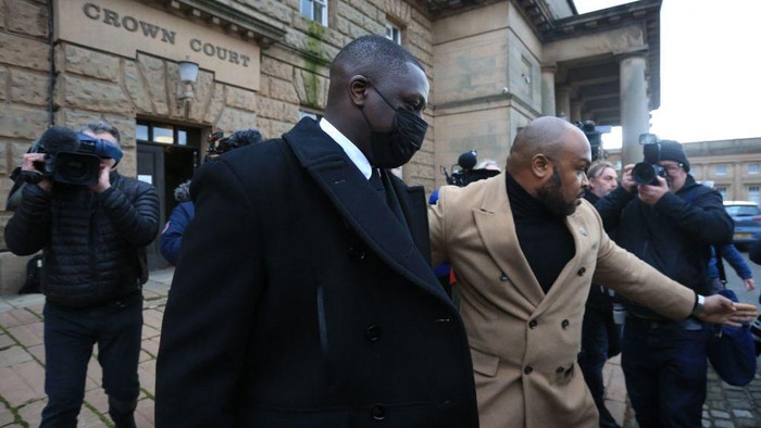 Manchester City and France international footballer Benjamin Mendy (C) leaves after a pre-trial hearing at Chester Crown Court in Chester, northwest England, on February 2, 2022. - Mendy, who has been charged with seven counts of rape, was freed on bail last month with stringent conditions, including the surrender of his passport. Mendy, who is accused by five women of seven counts of rape and one of sexual assault, has been in custody since being arrested and charged on August 26 last year. (Photo by Lindsey Parnaby / AFP) (Photo by LINDSEY PARNABY/AFP via Getty Images)