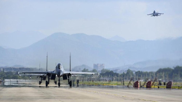 In this photo released by Chinas Xinhua News Agency, air force and naval aviation corps of the Eastern Theater Command of the Chinese Peoples Liberation Army (PLA) fly planes at an unspecified location in China, Thursday, Aug. 4, 2022. China conducted 