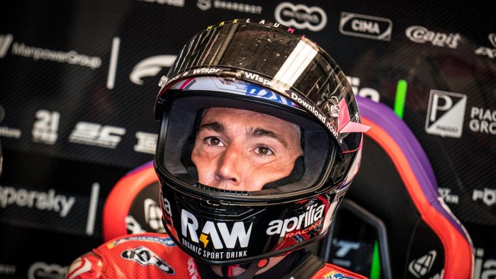 NORTHAMPTON, ENGLAND - AUGUST 06: Aleix Espargaro of Spain and Aprilia Racing sits inside his garage with his helmet during the qualifying session of the MotoGP Monster Energy British Grand Prix at Silverstone Circuit on August 06, 2022 in Northampton, England. (Photo by Steve Wobser/Getty Images)