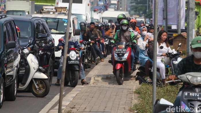 Sejumlah pemotor menyerobot trotoar untuk menembus macet di Ciputat, Tangsel. Padahal, trotoar semestinya digunakan pejalan kaki.