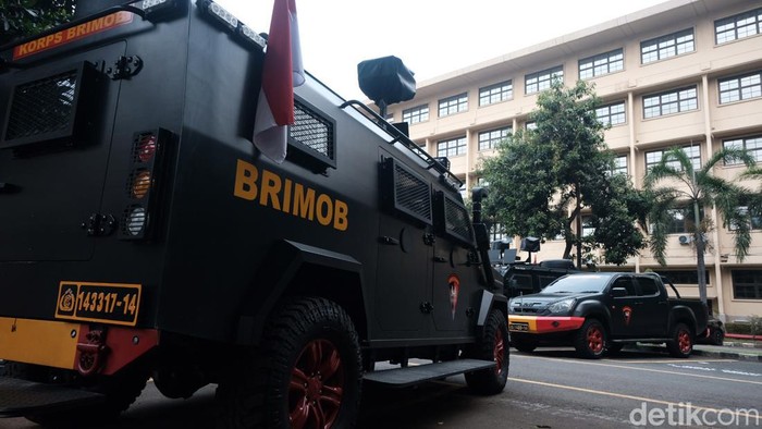 Sejumlah personel Brimob yang mendatangi gedung Bareskrim Polri. Kendaraan milik Korps Brimob masih terpakir sejak siang.