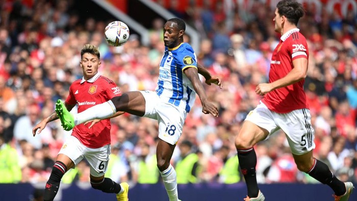 MANCHESTER, ENGLAND - AUGUST 07: Danny Welbeck of Brighton & Hove Albion is put under pressure by Lisandro Martinez (L) and Harry Maguire (R) of Manchester United during the Premier League match between Manchester United and Brighton & Hove Albion at Old Trafford on August 07, 2022 in Manchester, England. (Photo by Michael Regan/Getty Images)