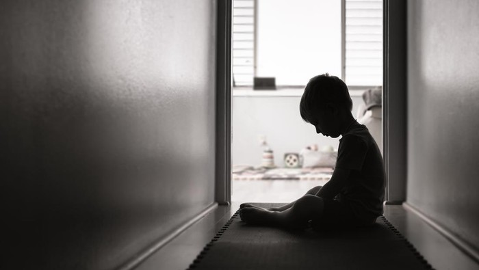 Sad boy sits alone.