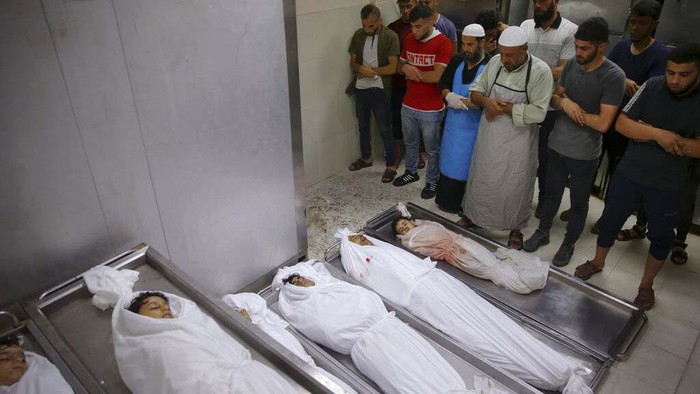 The body of Palestinian Muhammad Hassouna, who was killed in an Israeli airstrike is prepared for his funeral at a hospital in Rafah, in the southern Gaza Strip, Sunday, Aug. 7, 2022. An Israeli airstrike in Rafah killed a senior commander in the Palestinian militant group Islamic Jihad, authorities said Sunday, its second leader to be slain amid an escalating cross-border conflict. (AP Photo/Fatima Shbair)