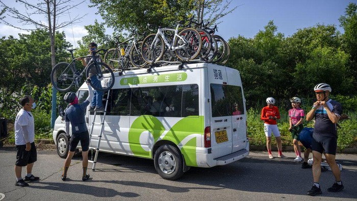 Members of the Qiyi bicycle club take a break at a mountain summit near the end of a group ride through the Baihe River Canyon in the northern outskirts of Beijing, Wednesday, July 13, 2022. Cycling has gained increasing popularity in China as a sport. A coronavirus outbreak that shut down indoor sports facilities in Beijing earlier this year encouraged people to try outdoor sports including cycling, which was only a major tool of transport before 2000. (AP Photo/Mark Schiefelbein)