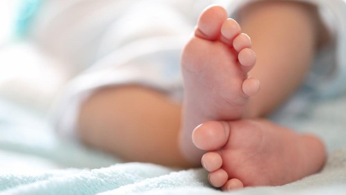 A close-up of tiny baby feet