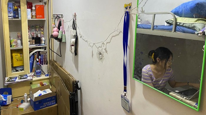 China Job Drought Recent college graduate Liu Qian sits in the room she rents in an apartment in Beijing, Thursday, July 7, 2022. Liu is one of 11 million new graduates desperate for work in a bleak job market as anti-virus controls force factories, restaurants and other employers to close. The survivors are cutting jobs and wages. (AP Photo/Olivia Zhang)