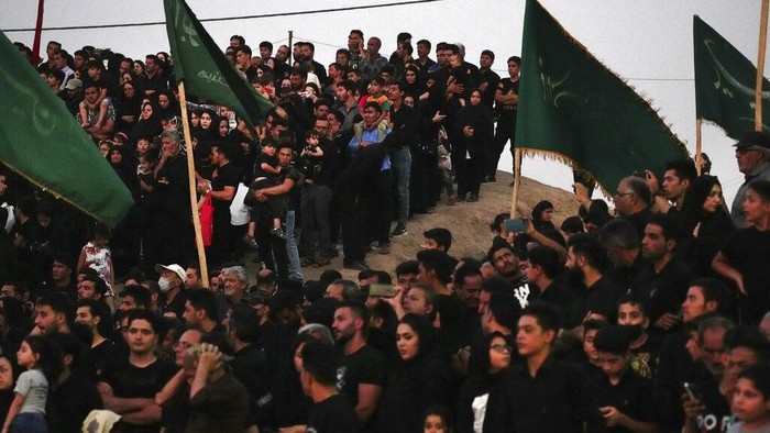 Actors perform during Tazieh, a traditional theater scene about the death of Imam Hussein, a grandson of Prophet Muhammad, in Noushabad, about 140 miles (233 kilometers) south of the capital Tehran, Iran, Tuesday, Aug. 9, 2022. The play re-enacts the battle of Karbala against the leader of what became the Sunni branch of Islam, in present-day Iraq, in which Hussein, one of Shiite Islam's most beloved saints, and 72 of his companions were killed. The actors represent enemies of Imam Hussein. (AP Photo/Vahid Salemi)