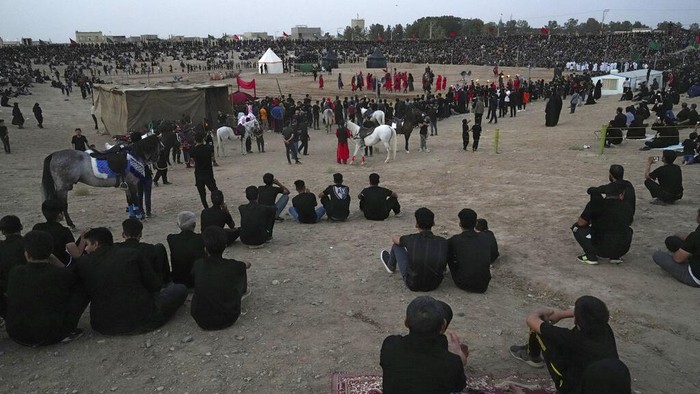 Iran Shiites Actors perform during Tazieh, a traditional theater scene about the death of Imam Hussein, a grandson of Prophet Muhammad, in Noushabad, about 140 miles (233 kilometers) south of the capital Tehran, Iran, Tuesday, Aug. 9, 2022. The play re-enacts the battle of Karbala against the leader of what became the Sunni branch of Islam, in present-day Iraq, in which Hussein, one of Shiite Islam's most beloved saints, and 72 of his companions were killed. The actors represent enemies of Imam Hussein. (AP Photo/Vahid Salemi)
