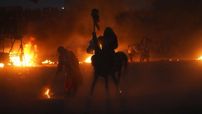 Actors perform during Tazieh, a traditional theater scene about the death of Imam Hussein, a grandson of Prophet Muhammad, in Noushabad, about 140 miles (233 kilometers) south of the capital Tehran, Iran, Tuesday, Aug. 9, 2022. The play re-enacts the battle of Karbala against the leader of what became the Sunni branch of Islam, in present-day Iraq, in which Hussein, one of Shiite Islam's most beloved saints, and 72 of his companions were killed. The actors represent enemies of Imam Hussein. (AP Photo/Vahid Salemi)