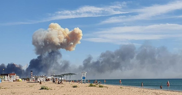 Rising smoke can be seen from the beach at Saky after explosions were heard from the direction of a Russian military airbase near Novofedorivka, Crimea, Tuesday Aug. 9, 2022. The explosion of munitions caused a fire at a military air base in Russian-annexed Crimea Tuesday but no casualties or damage to stationed warplanes, Russias Defense Ministry said. (UGC via AP)