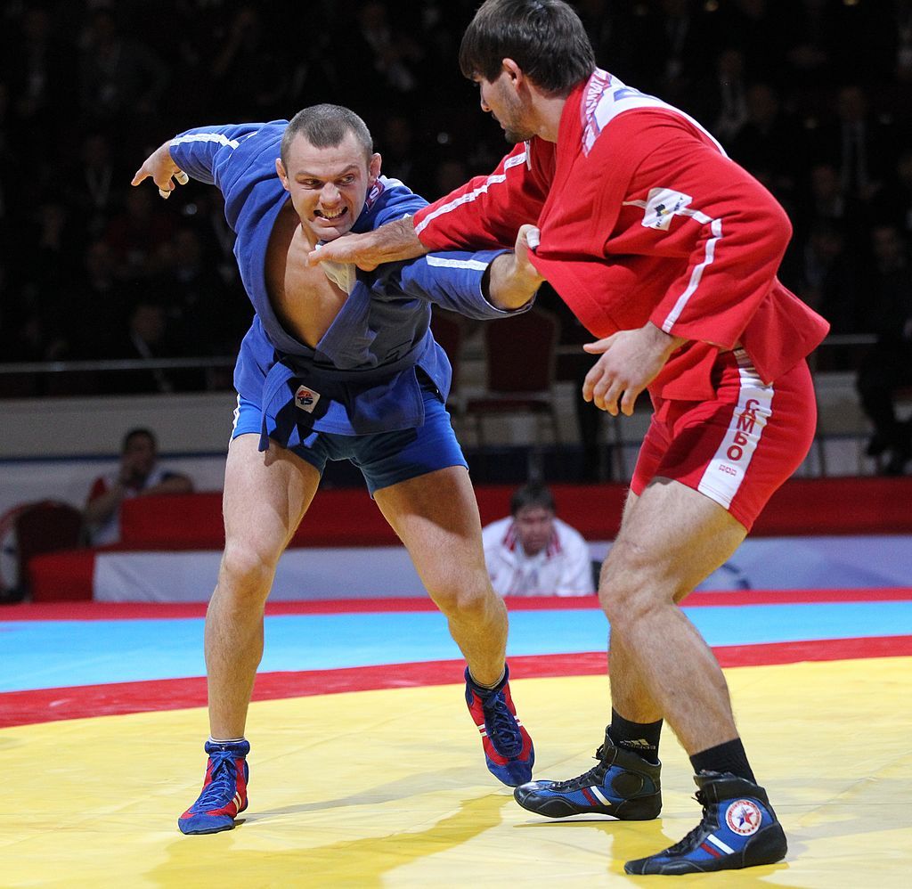MOSCOW, RUSSIA - NOVEMBER 22: Russian athlete Arsen Khandhzian (R) fights with Ukraine athlet Ivan Vasylchuk (L) as Russian President Vladimir Putin attends the World Sambo Championship on November 22, 2013 in Saint Petersburg, Russia. Putin also today met with Turkish Prime Minister Tayyip Erdogan.  (Photo by Sasha Mordovets/Getty Images)
