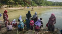 Siswa SD ditemani orang tuanya menunggu rakit bambu di Desa Haurgajrug, Lebak, Banten, Selasa (9/8/2022). 