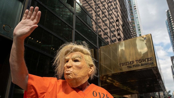 A former U.S. President Donald Trump supporter wears a Trump necklace at Trump Tower two days after Trump said that FBI agents raided his Mar-a-Lago Palm Beach home, in New York City, U.S., August 10, 2022. REUTERS/David 'Dee' Delgado