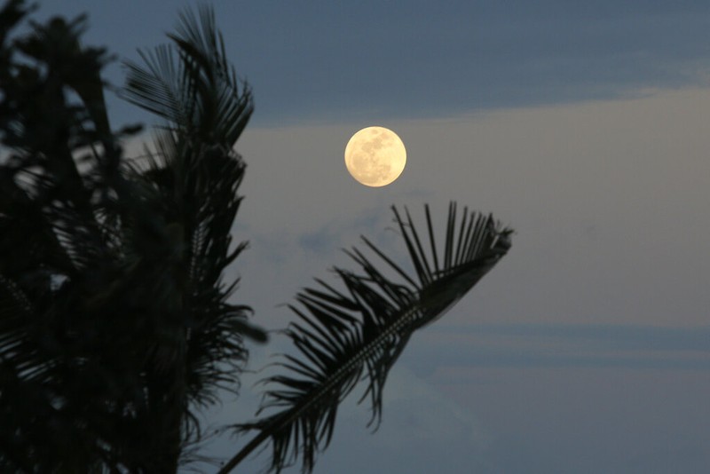 A Supermoon rises in the night sky in Beijing, Thursday, Aug. 11, 2022. (AP Photo/Ng Han Guan)