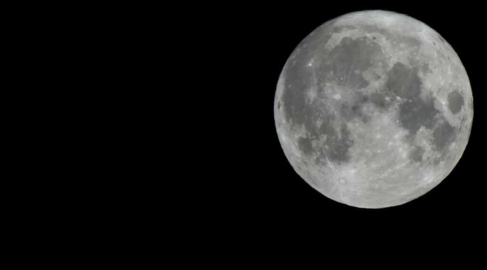 A Supermoon rises in the night sky in Beijing, Thursday, Aug. 11, 2022. (AP Photo/Ng Han Guan)