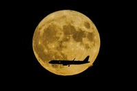 A Supermoon rises in the night sky in Beijing, Thursday, Aug. 11, 2022. (AP Photo/Ng Han Guan)