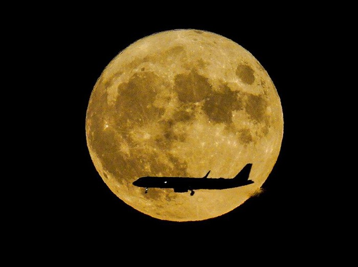 A Supermoon rises in the night sky in Beijing, Thursday, Aug. 11, 2022. (AP Photo/Ng Han Guan)