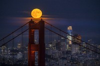 A Supermoon rises in the night sky in Beijing, Thursday, Aug. 11, 2022. (AP Photo/Ng Han Guan)