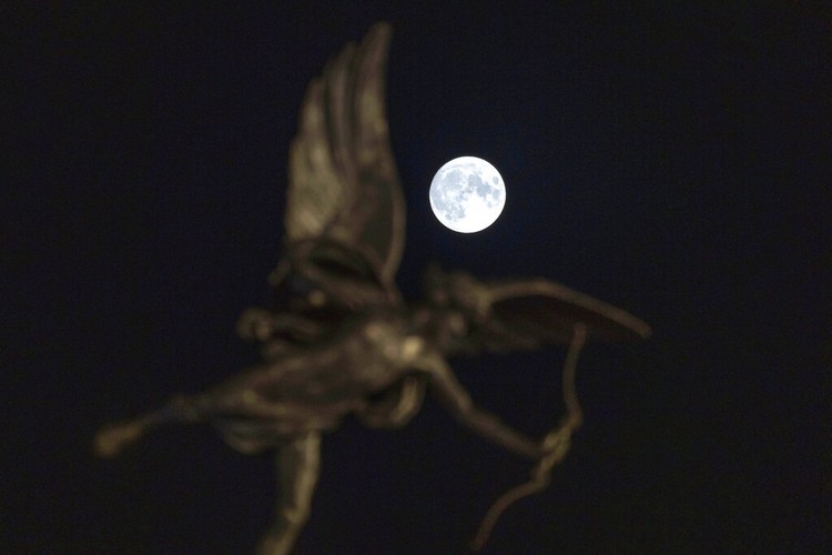 A Supermoon rises in the night sky in Beijing, Thursday, Aug. 11, 2022. (AP Photo/Ng Han Guan)