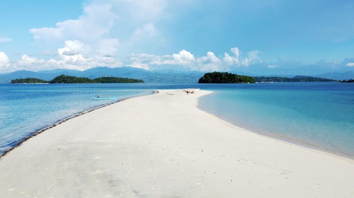 Wisatawan mengunjungi Pulau Bugisa di Kecamatan Ponelo Kepulauan, Kabupaten Gorontalo Utara, Gorontalo, Jumat (12/8/22). Hamparan pasir putih, air laut yang jernih dan pepohonan hijau menjadi daya tarik salah satu objek wisata bahari unggulan yang ada di daerah itu. ANTARA FOTO/Adiwinata Solihin/rwa.