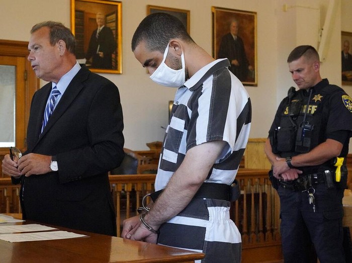 Hadi Matar, 24, center, arrives for an arraignment in the Chautauqua County Courthouse in Mayville, N.Y., Saturday, Aug. 13, 2022. Matar, who is accused of carrying out a stabbing attack against “Satanic Verses” author Salman Rushdie has entered a not-guilty plea in a New York court on charges of attempted murder and assault. An attorney for Matar entered the plea on his behalf during an arraignment hearing.  (AP Photo/Gene J. Puskar)