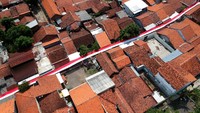 Bendera sepanjang 150 meter itu berada di tengah permukiman penduduk. Bendera dijahit selama lima hari.