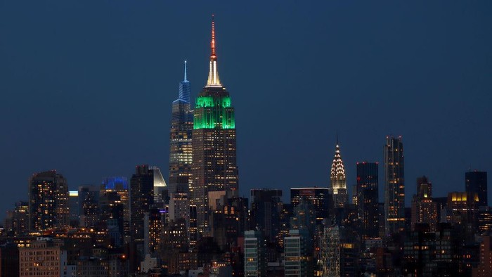 1415081544 JERSEY CITY, NJ - AUGUST 15: The Empire State Building is lit in the colors of the flag of India, which is marking its 75th year of independence, in New York City on August 15, 2022, as seen from Jersey City, New Jersey. (Photo by Gary Hershorn/Getty Images)