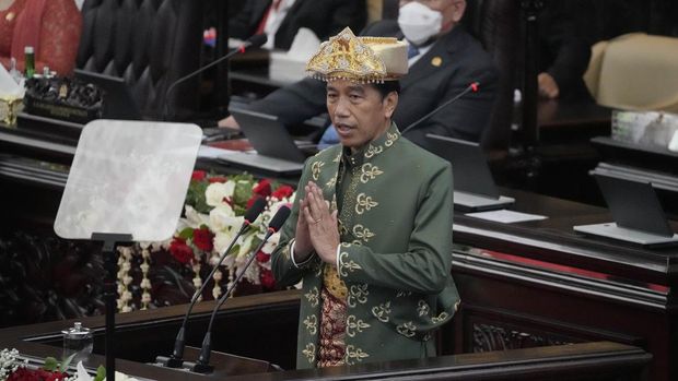 Indonesian President Joko Widodo, wearing traditional Bangka Belitung outfit, gestures as he delivers his annual State of the Nation Address ahead of the country's Independence Day, at the parliament building in Jakarta, Indonesia, Tuesday, Aug. 16, 2022. (AP Photo/Tatan Syuflana, Pool)