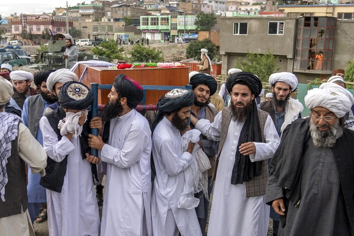 Afghanistan Taliban fighters and local residents gather around a mosque that has been bombed, in Kabul, Afghanistan, Thursday, Aug. 18. 2022. A bombing at a mosque in Kabul during evening prayers on Wednesday killed at least 10 people, including a prominent cleric, and wounded over two dozen, an eyewitness and police said. (AP Photo/Ebrahim Noroozi)