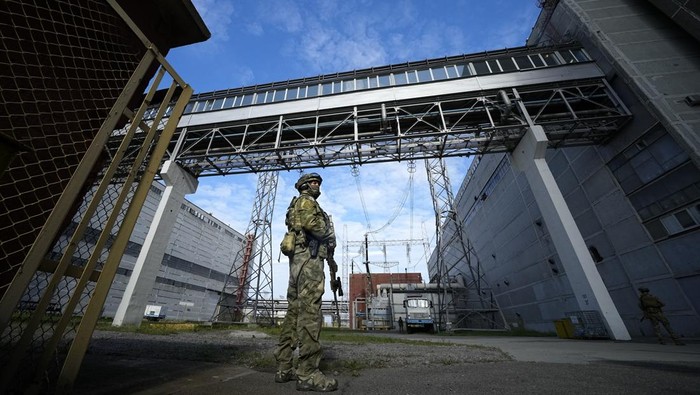 FILE - A Russian serviceman guards an area of the Zaporizhzhia Nuclear Power Station in territory under Russian military control, southeastern Ukraine, May 1, 2022. Russia and Ukraine have trade blame over shelling of the Zaporizhzhia nuclear power plant, Europe's largest. This photo was taken during a trip organized by the Russian Ministry of Defense. (AP Photo, File)