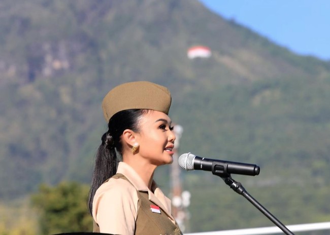 Mengenakan outfit bernuansa coklat, Yuni Shara tampil sebagai pembina upacara. Dengan pulasan makeup natural, penampilan Yuni tampak begitu memukau. Foto: Instagram/@yunishara36