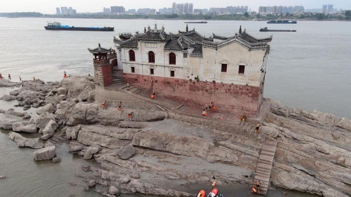Bangunan 700 Tahun Muncul di Sungai Yangtze Pemandangan udara Paviliun Guanyin, yang telah berdiri di Sungai Yangtze selama lebih dari 700 tahun, muncul kembali dari bawah air saat Sungai Yangtze China mengalami kekeringan pada 20 Agustus 2022 di Ezhou, Provinsi Hubei, China.
