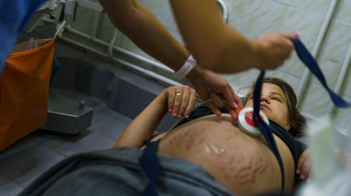 Dr. Tetiana Myroshnychenko, a neonatologist at Pokrovsk Perinatal Hospital, checks on Veronika, a baby born nearly two months prematurely, in Pokrovsk, Donetsk region, eastern Ukraine, Monday, Aug. 15, 2022. In Ukraine’s war-torn eastern Donetsk region, only one hospital under government control remains equipped to care for babies born prematurely in government-held areas. Doctors say the stress caused by the war and rapidly worsening living conditions are leading to more frequent birth complications for the area's pregnant women.  (AP Photo/David Goldman)