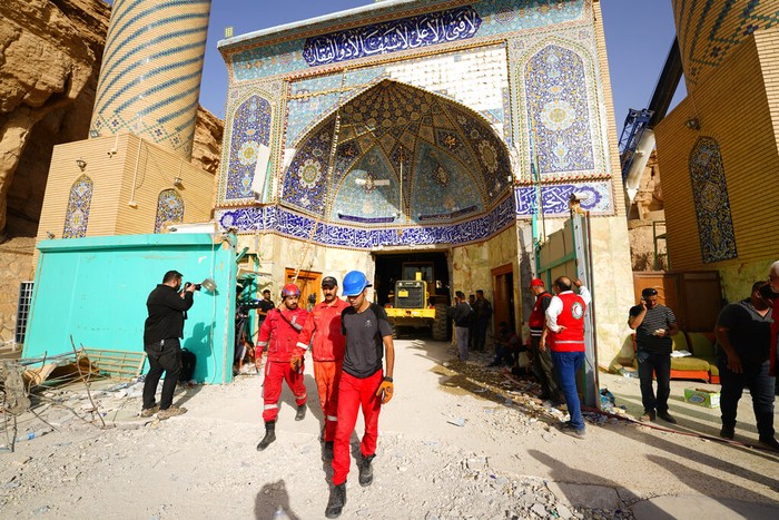 Tanah longsor menimpa kuil Qattarat al-Imam Ali. Emergency services and rescue workers are seen at Qattarat al-Imam Ali shrine near Karbala, Iraq, Sunday, Aug. 21, 2022. Several people died and others were trapped under the rubble after a mound collapsed onto the shrine. (AP Photo/Anmar Khalil)