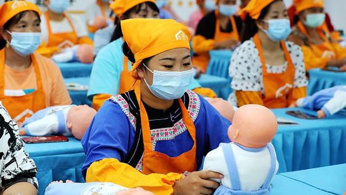 QIANDONGNAN, CHINA - AUGUST 22: Rural women learn baby care skills at a training center of Rongjiang County on August 22, 2022 in Qiandongnan Miao and Dong Autonomous Prefecture, Guizhou Province of China. (Photo by Li Changhua/VCG via Getty Images)