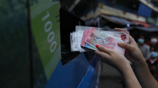 Warga antre untuk menukarkan uang baru tahun emisi 2022 di Pasar Slipi, Jakarta, Selasa (23/8/2022). (CNBC Indonesia/Tri Susilo)
